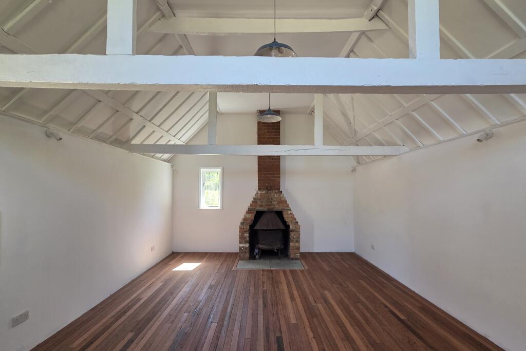 Open plan living room with wood burning stove at The Bothy, Standinghall Lane, Turners Hill